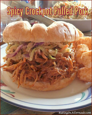 Spicy Crockpot Pulled Pork: slow cooked in a sauce with a bit of a kick, this versatile recipe can be served over rice, potatoes, or as a sandwich. | recipe developed by www.BakingInATornado.com | #recipe #dinner