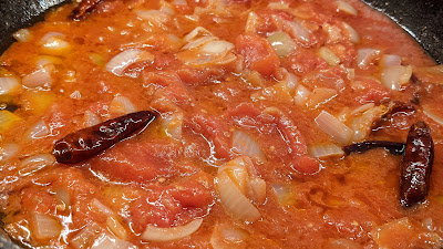 Fry for 10 minutes till the onions are soft. Remove the potato. Add the chopped tomatoes and fry for 5 minutes