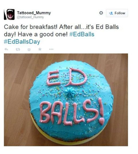 image of a blue cake with the words Ed Balls iced on in pink