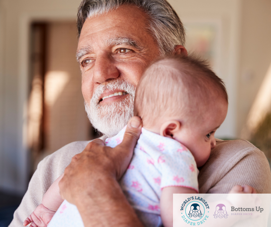 Hispanic grandfather holding his baby grandson