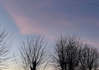 Moon in sunrise clouds