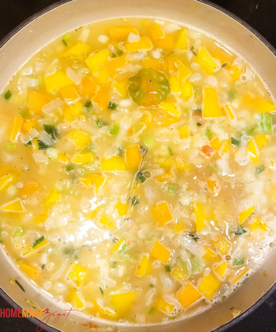 Jamaican pumpkin rice being simmered in water with spices