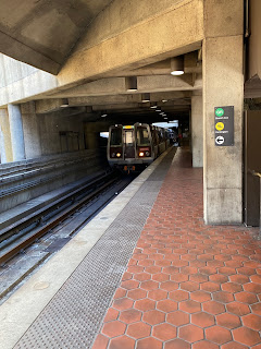 Green Line Metro train exiting a tunnel into the Fort Totten Metro station