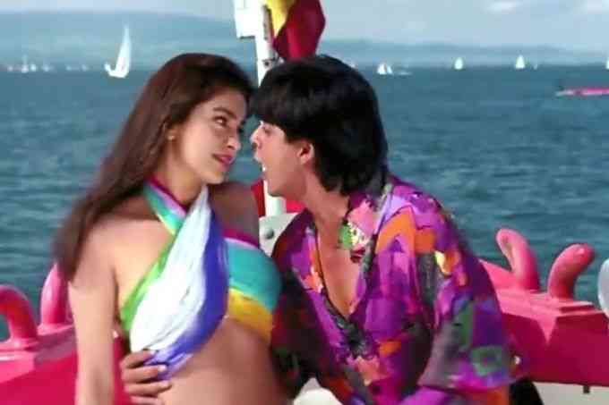 Shahrukh and Juhi on a boat in tu mere samne song wearing colorful dresses