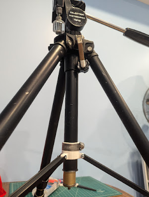 The attachment fastened to the central pole of a Celestron Photographic Tripod.