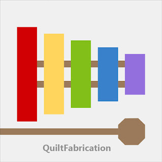 xylophone quilt block with five different colored bars plus hammer