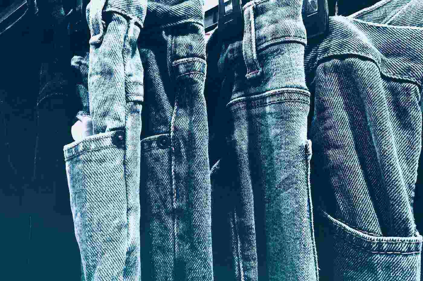 jeans hanging side by side - cotton care - making your clothes investments last