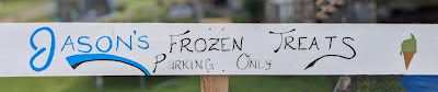 a hand painted sign says "Jason's Frozen Treats customer parking only"