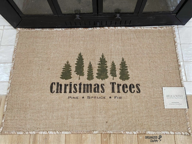 Photo of a jute rug, new with tag, from the thrift store stenciled with Christmas Trees stencil from Old Sign Stencils.