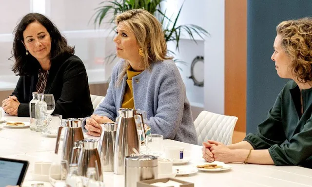 Queen Maxima's outfit (Blue coat, yellow top and pants) is from the fashion house Natan. Rough Studios Bandita mini velvet handbag