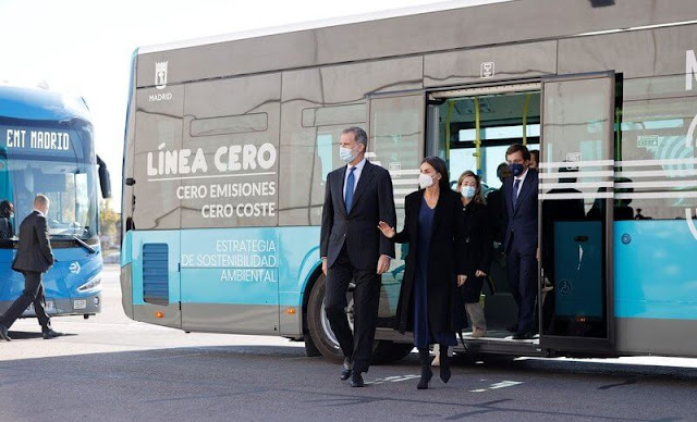 Queen Letizia wore a black a-line belted coat by Carolina Herrera, and blue v-neck dress by Massimo Dutti. Steve Madden boots
