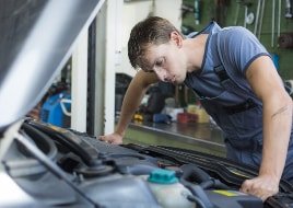 Expert checking the alternator in a workshop