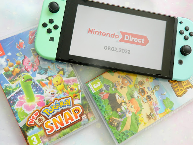 A photo showing a pastel blue and green Nintendo Switch console, alongside two games: Pokemon Snap and Animal Crossing New Horizons