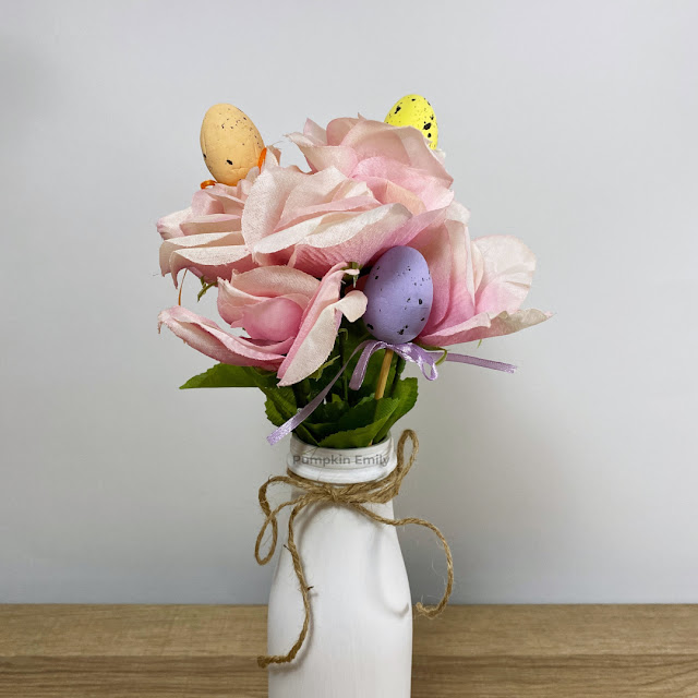 A close up of a spring themed flower arrangement.