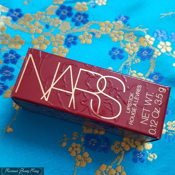 NARS lipstick box in deep glossy red with raised floral design and gold lettering