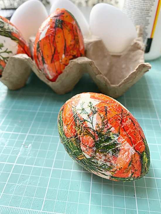 carton of eggs and decoupaged egg