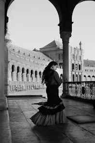 A black and white image of a flamenco female dancer at the Seville plaza by Al Cabri, Seville Spain 2021