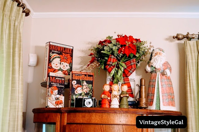 Closer look of top of china cabinet, vintage snowmen books, vintage decor on top