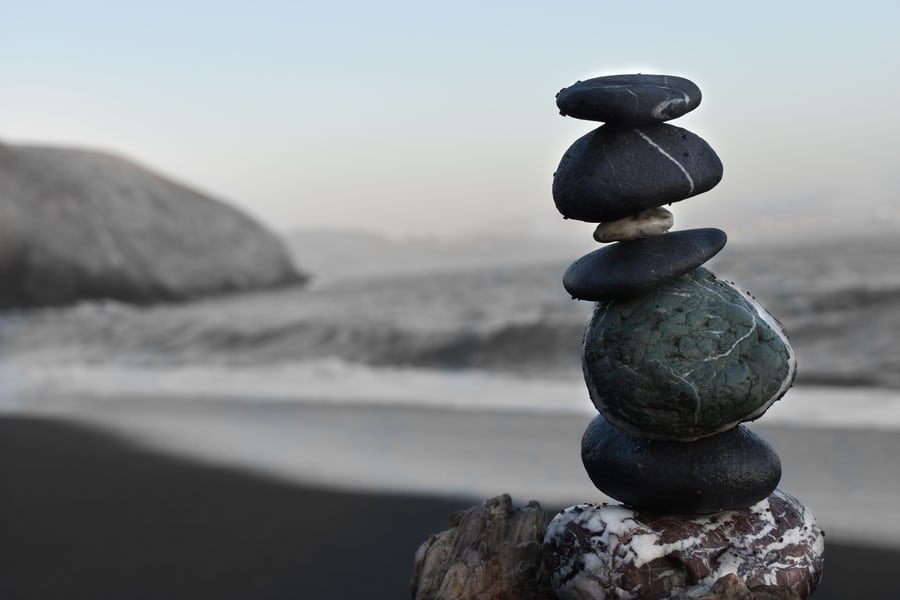 A vertically arranged pebbles/rocks depicting weight loss myths