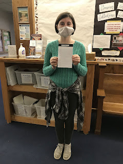 woman stands with note pad, one of the sensory library items