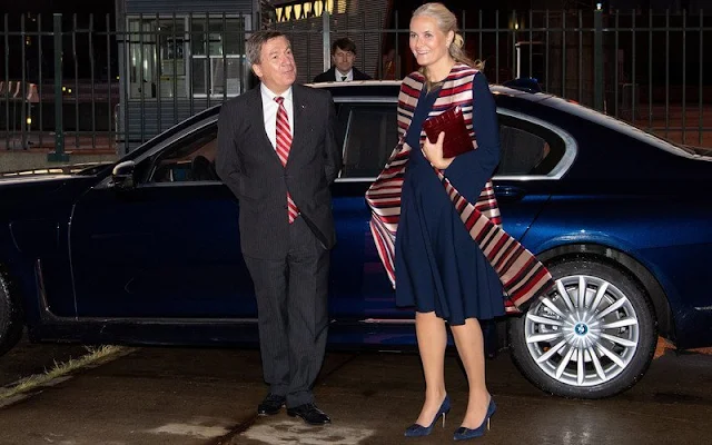 Crown Princess Mette Marit wore a satin stripe sleeveless trench coat by Tome. Queen Maxima wore a navy and beige dress by Jan Taminiau