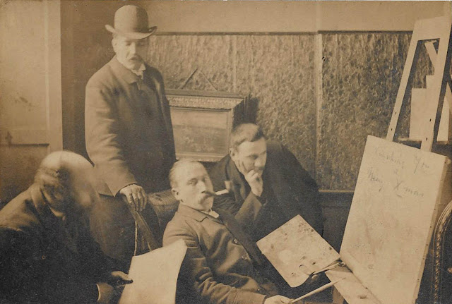 Photo of friendly critics in an artist's studio, commented "James Irving is the man with the pipe," by anonymous, circa 1888.