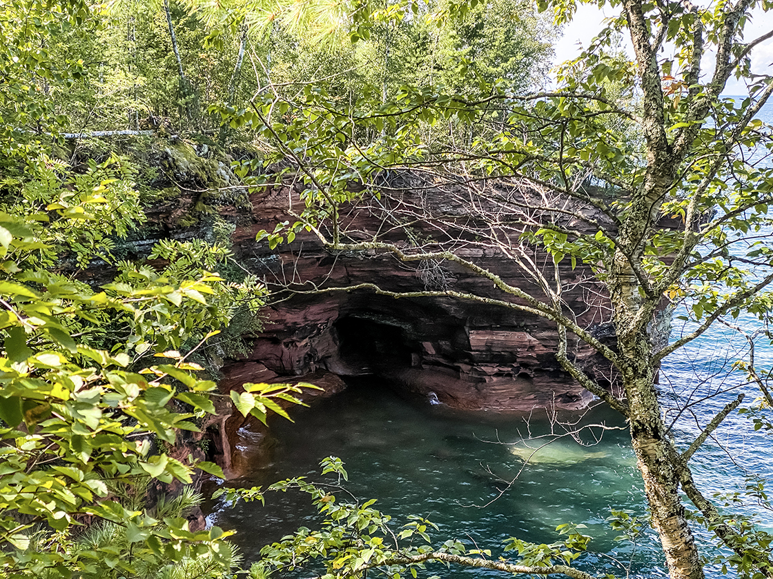 green water in stone cove with shallow sea caves