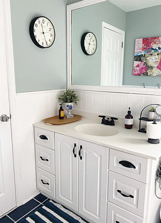 finished bathroom vanity with black hardware and faucet