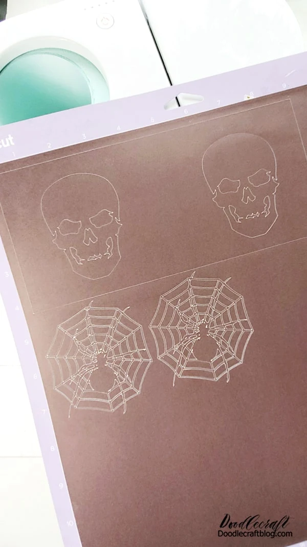 Step 1: Cut Infusible Ink Begin by selecting a design from Cricut Design Space. I picked a skull and a spider in a web. I love that the skull released the shape that I could use on a second mug.  Design the canvas by selecting the square shape, place one on the canvas, then unclick the lock icon so you can change the measurements separate of each other. Make the width 8.75 inches and the height 4 inches.   Then add the skull image on both sides of the rectangle, slice the images together and boom, ready to cut!   Mirror the image. Place the infusible ink on the strong grip mat and use the brayer to roll it in place. touch it as little as possible.  Then select the material and cut it out.