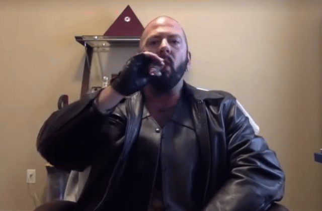 Bald extremely sexy bear daddy wearing leather jacket with vest underneath smoking a fat cigar and teasing all the horny kinky folks with bearded sex appeal.