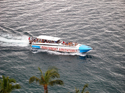 Powerboat with passengers moving on the sea.