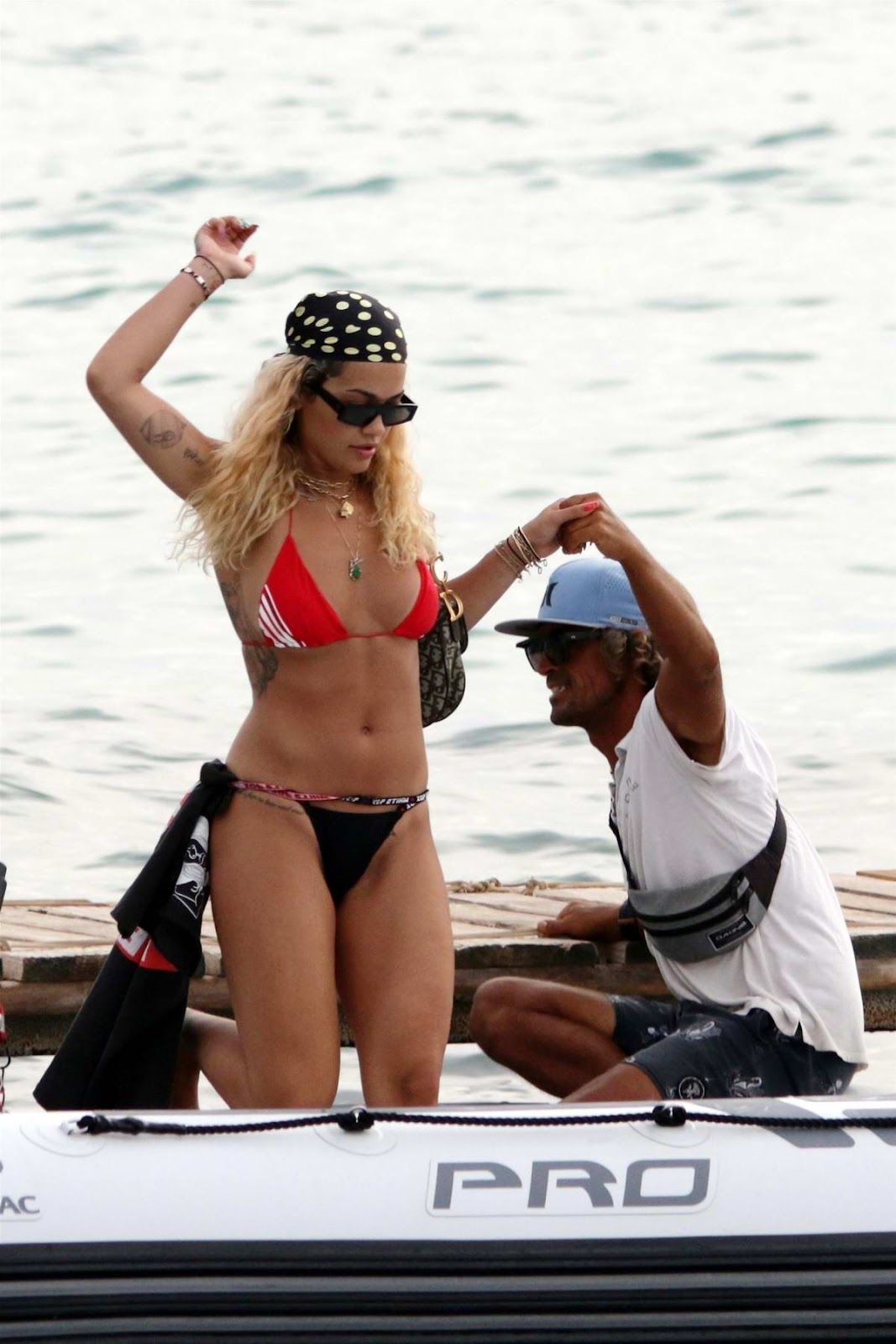 Rita Ora seen wearing a red and black bikini while enjoying a boat ride with friends in Ibiza, Spain