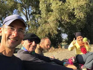 four hikers sitting on the ground taking a break