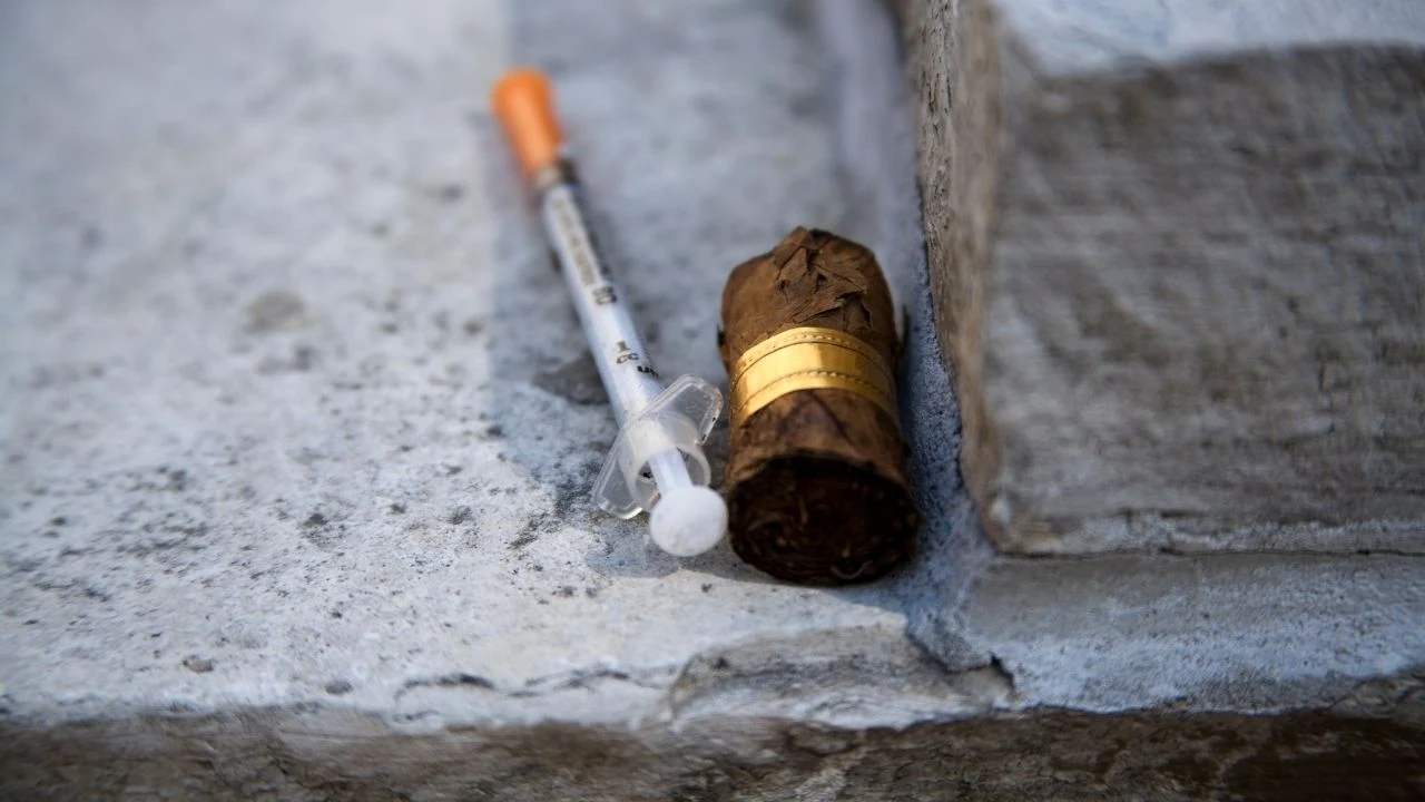 Syringe and used cigar butt left behind by a drug addict.