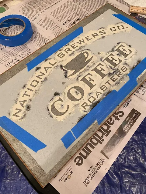 Photo of a National Brewers Coffee Roasters stencil from Old Sign Stencils taped onto a metal sheet.