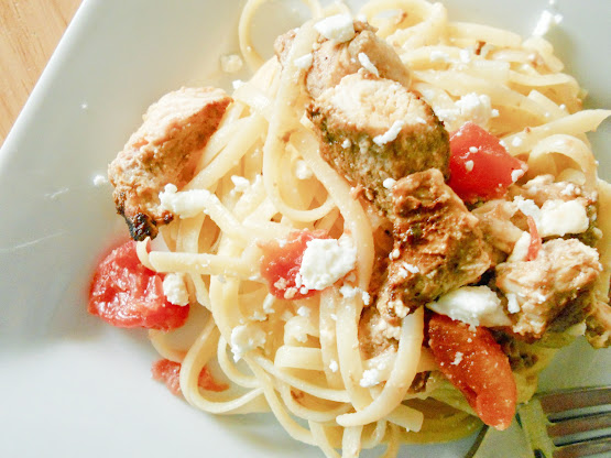 Greek pasta with tomatoes plated on a white dinner plate