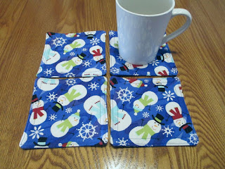 Hand-sewn quilted coasters with snowman design