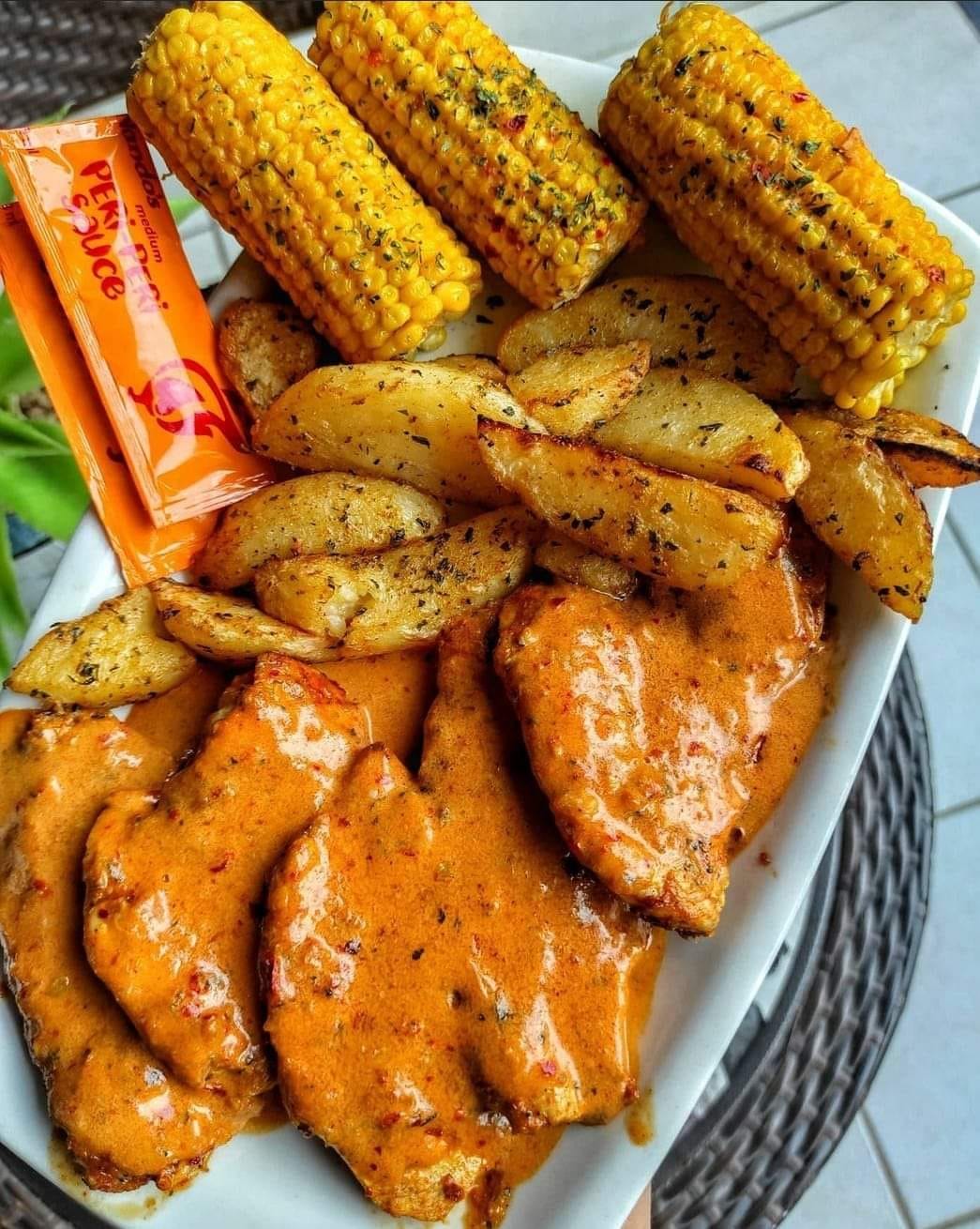 Nando chicken served with wedges and spiced corn