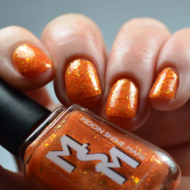 orange nail polish with flakies swatch