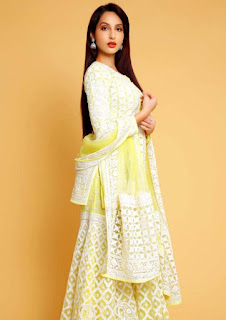 nora in traditional white lehnga chunri with yellow ocher background