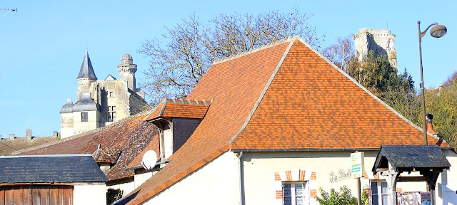 Chateau du Grand Pressigny appearing over the roof of a house, Indre et Loire, France. Photo by Loire Valley Time Travel.