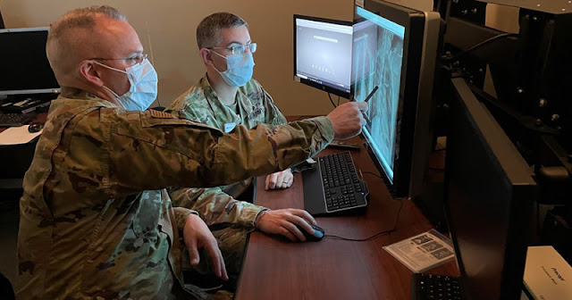 Col. Lattin reviewing a chest radiograph with a colleague. (Photo credit: Courtesy of Col. Grant Lattin)