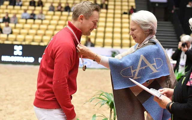 Princess Benedikte wore an Equi cashmere blue poncho by Adamsbro. Warmblood Stallion Show 2022 at Jyske Bank Boxen