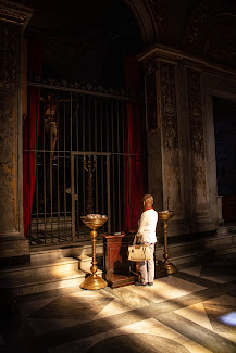 Woman praying at a church in Italy