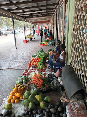 Hawkers selling vegetables on the pavement near Fawlty Tower  Backpackers.