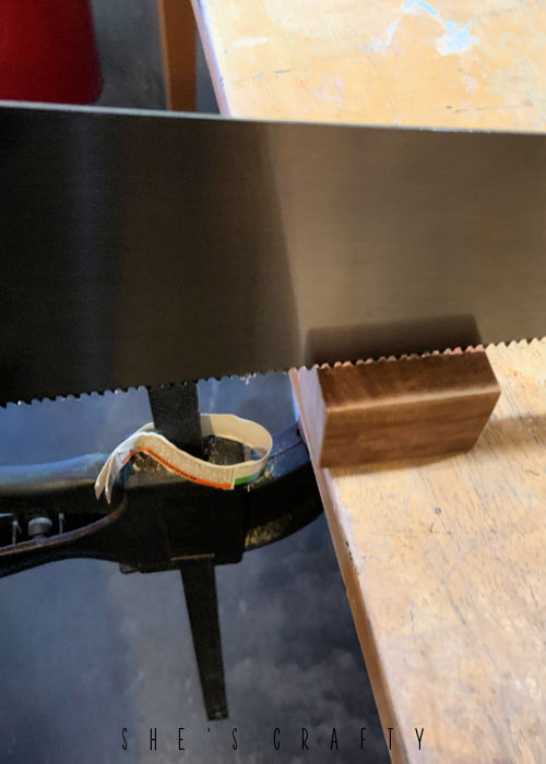 Use a hand saw to make a channel in a wooden block.