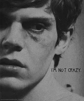 Close up half face photograph of a bruised Evan Peters with the captions I'm Not Crazy