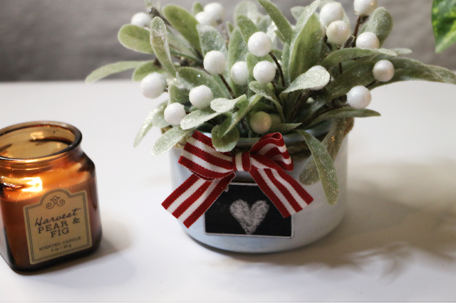 faux winter floral inside of painted blue candle jar, with mini chalkboard and bow