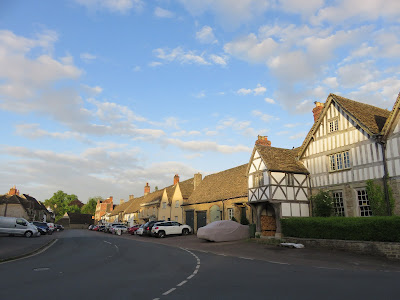 village street with timber frame building in foreground