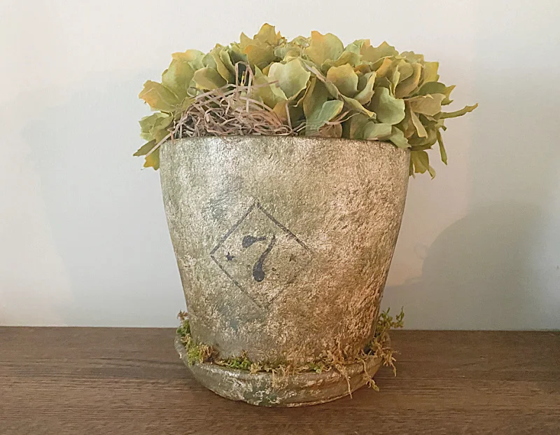 moss covered pot with flowers